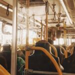 Interior view of a bus with people on a typical public transportation commute.