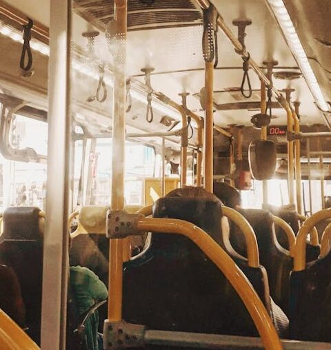 Interior view of a bus with people on a typical public transportation commute.