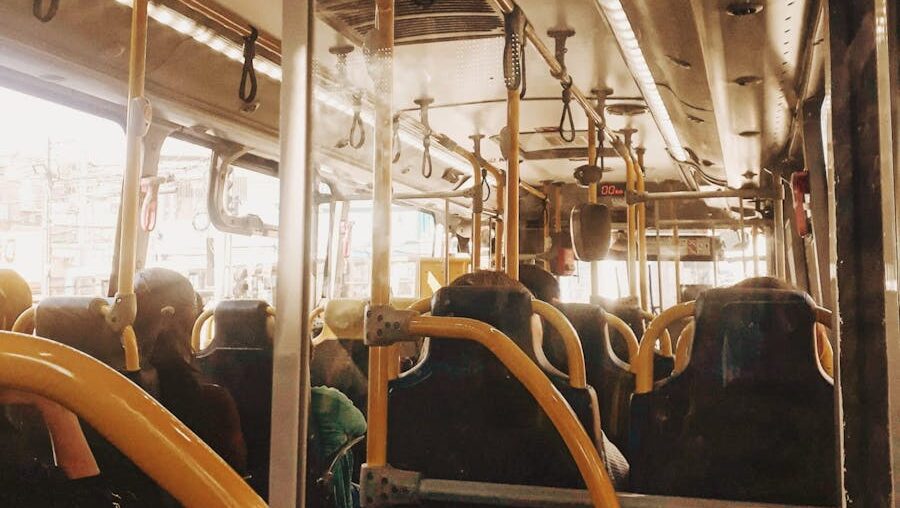 Interior view of a bus with people on a typical public transportation commute.