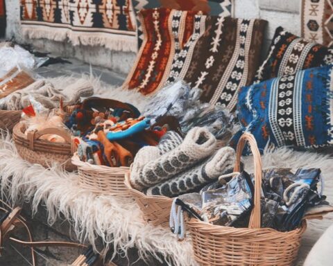Diverse handmade textiles and crafts on display at an outdoor cultural bazaar.