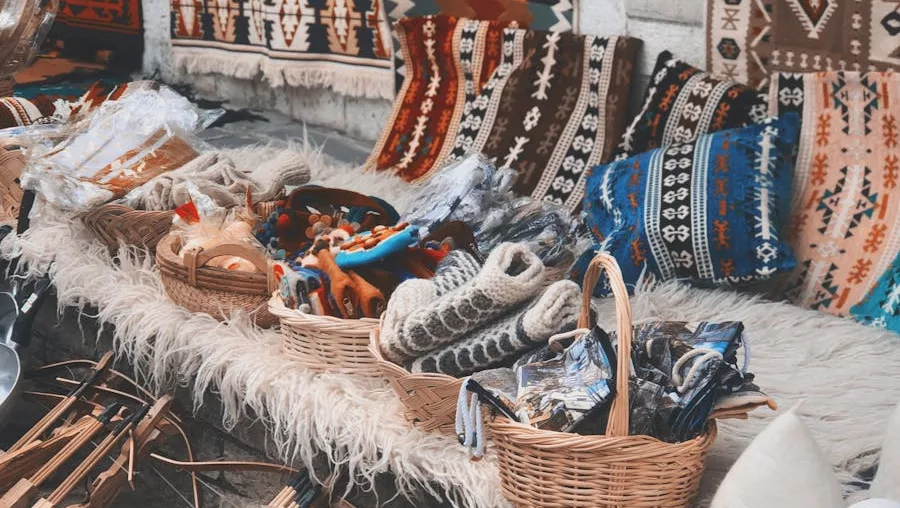 Diverse handmade textiles and crafts on display at an outdoor cultural bazaar.