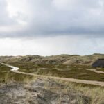 Beautiful dune landscape with traditional house on Amrum Island, Germany.
