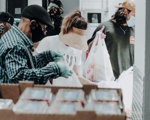 people standing in front of brown cardboard boxes