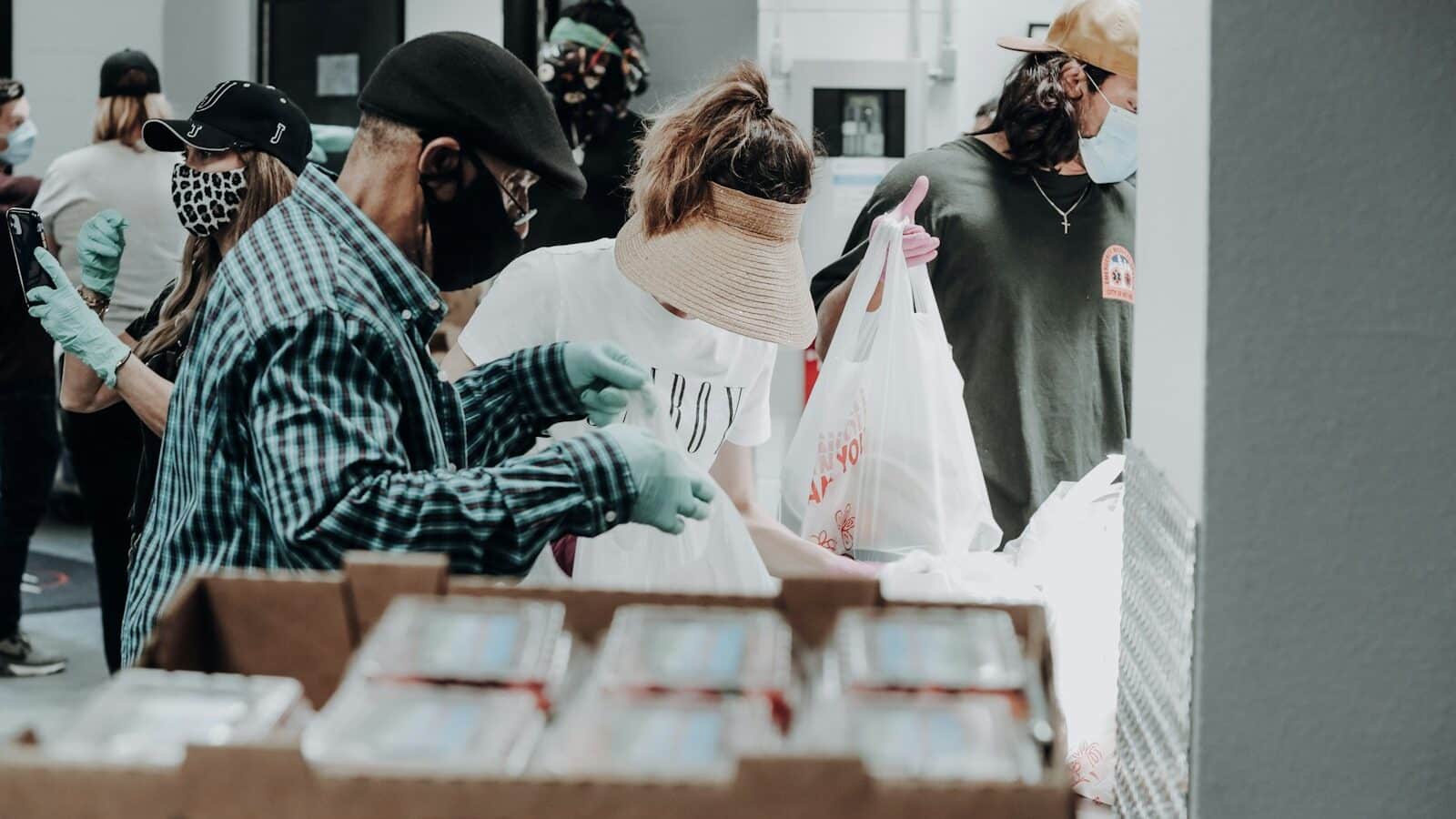 people standing in front of brown cardboard boxes