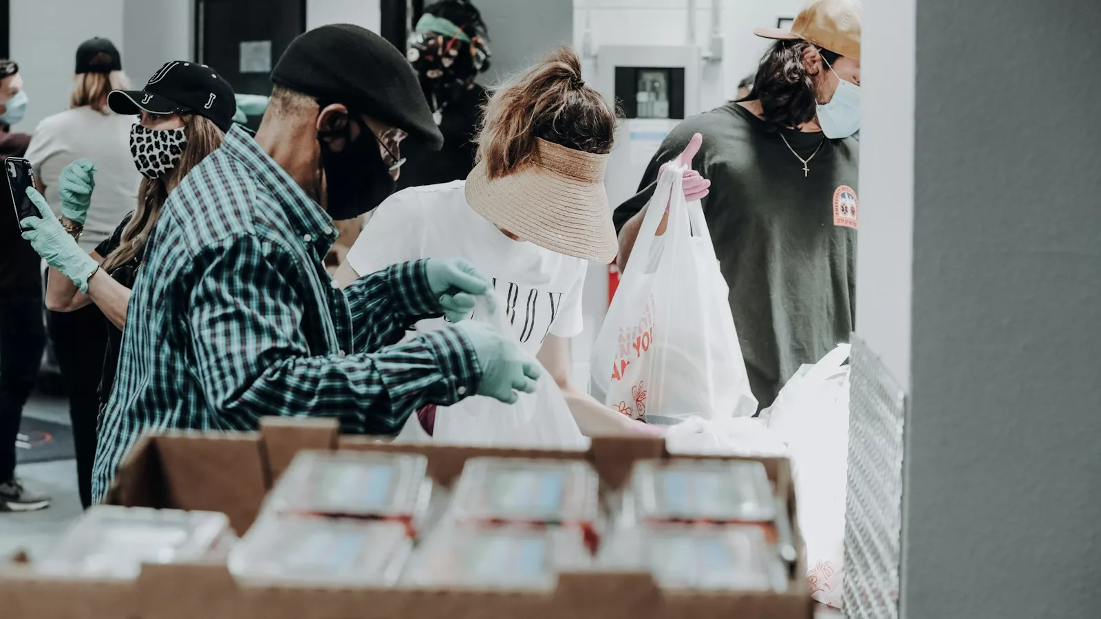 people standing in front of brown cardboard boxes